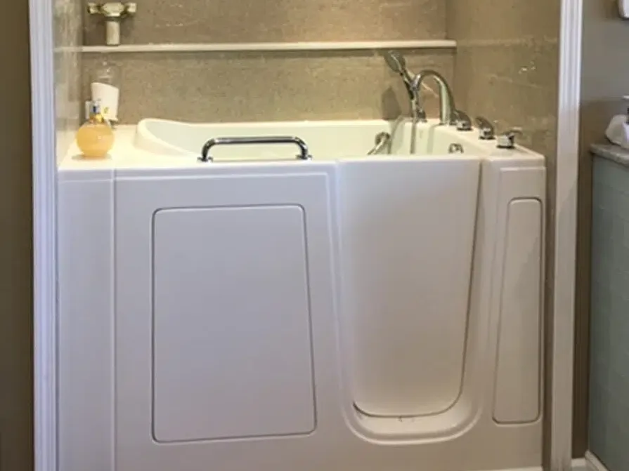 Walk-in bathtub with grab bar and built-in seat